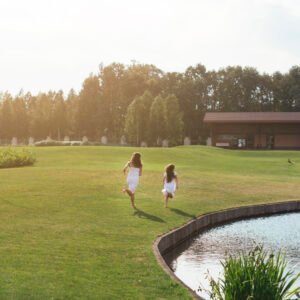 long-shot-mother-daughter-running-outdoors