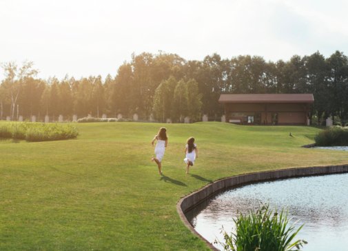 long-shot-mother-daughter-running-outdoors